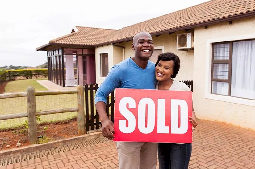 sold sign young couple ne