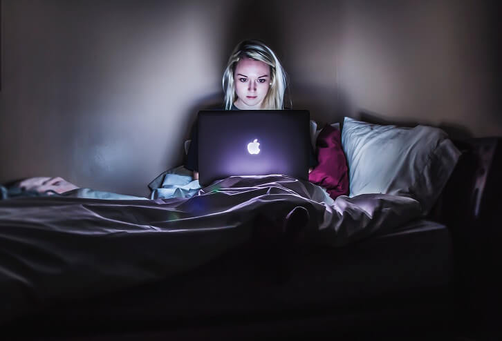 girl using laptop in bed buy now pay later 2019 plans and target government regulators